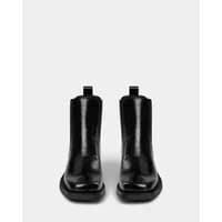 Black leather ankle boots with a glossy finish, rounded toe, and pull tabs by Sofie Schnoor.