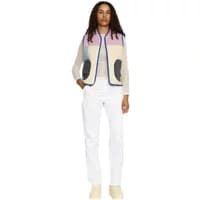 Women's quilted patchwork down jacket with pastel panels, blue trim, and black pockets by Selfhood.
