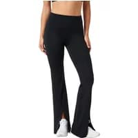 Black flared women's trousers by Björn Borg Studio, high-waisted with side slits, paired with white sneakers.