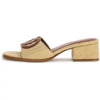 Beige woven heeled mules by Guess with open toe, brown logo detail, and block heel.