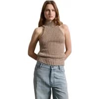 Beige knitted tank top with high neck and ribbed texture, worn by a model with light blue jeans.