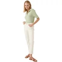 Green women's polo shirt by Artlove Cephalia, short sleeves, collared, paired with white pants.
