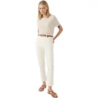 Beige women's short sleeve sweater by Artlove Felicea, round neckline, relaxed fit, paired with white pants.