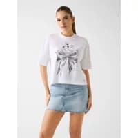 Light blue denim mini skirt with frayed hem, worn by a model, part of Guess Layla collection.