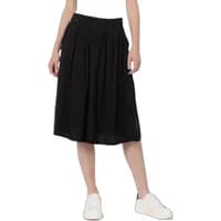Black Ragwear Delise women's skirt, knee-length with pleated design, worn with white sneakers.
