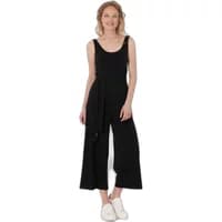 Black sleeveless jumpsuit by Ragwear, featuring a wide-leg design and waist tie, worn by a woman with white sneakers.