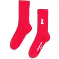 Red women's socks by ARMEDANGELS with white logo and text, ribbed texture, crew length.