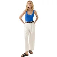 Blue Artlove Cyrilla women's tank top, sleeveless with scoop neckline, paired with white pants and black sandals.