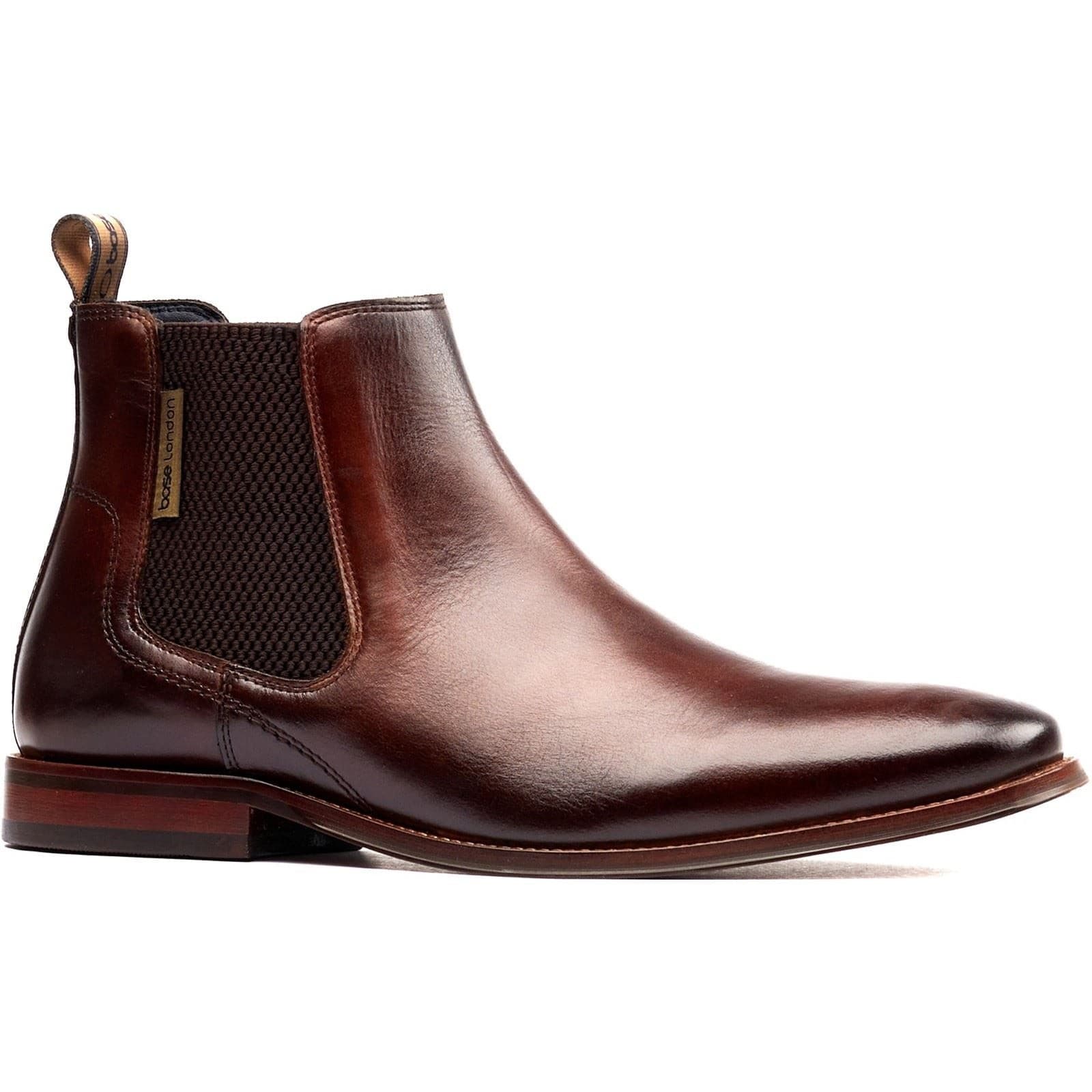 Brown leather Chelsea boots featuring elastic side panels, a sleek silhouette, and a pull tab for easy wear, designed for a stylish and comfortable fit.