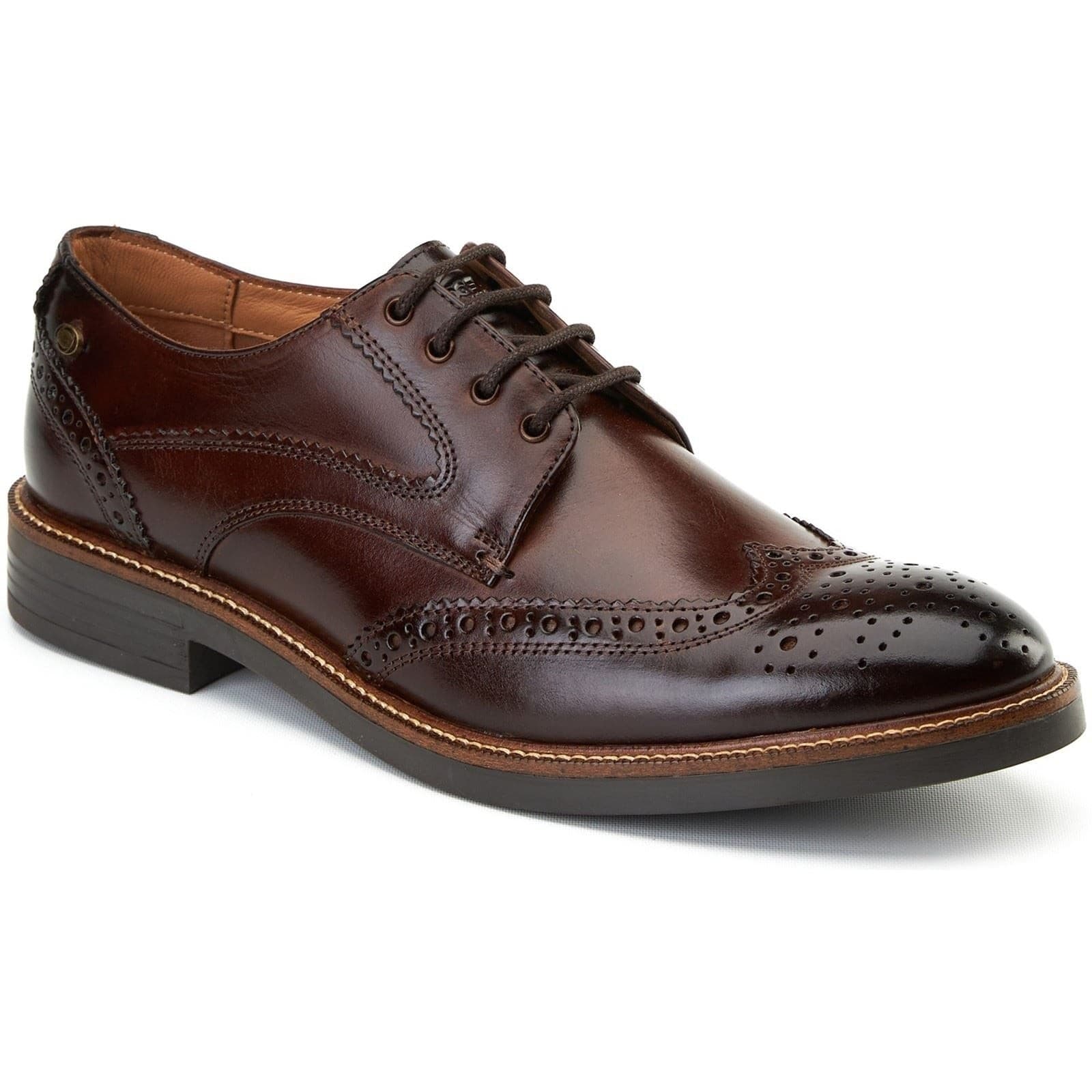 Burnt brown leather brogues featuring decorative perforations, a smooth toe cap, and a sturdy lace-up design with a low stacked heel.