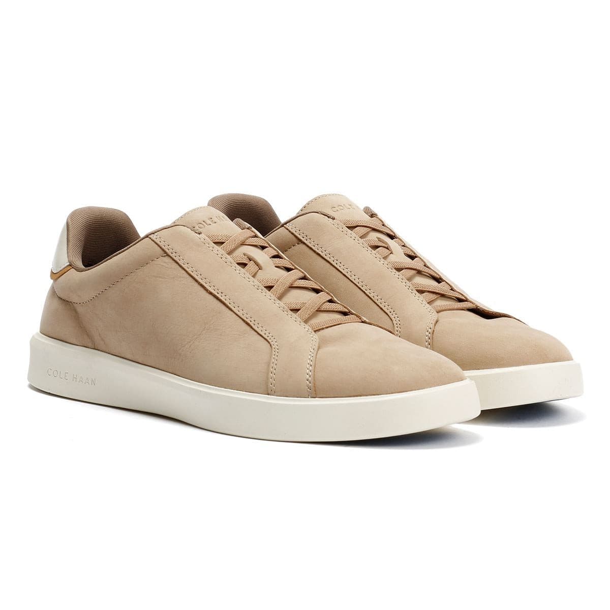 Light beige leather slip-on sneakers with a minimalist design, featuring a smooth finish, subtle stitching details, and a white rubber sole.