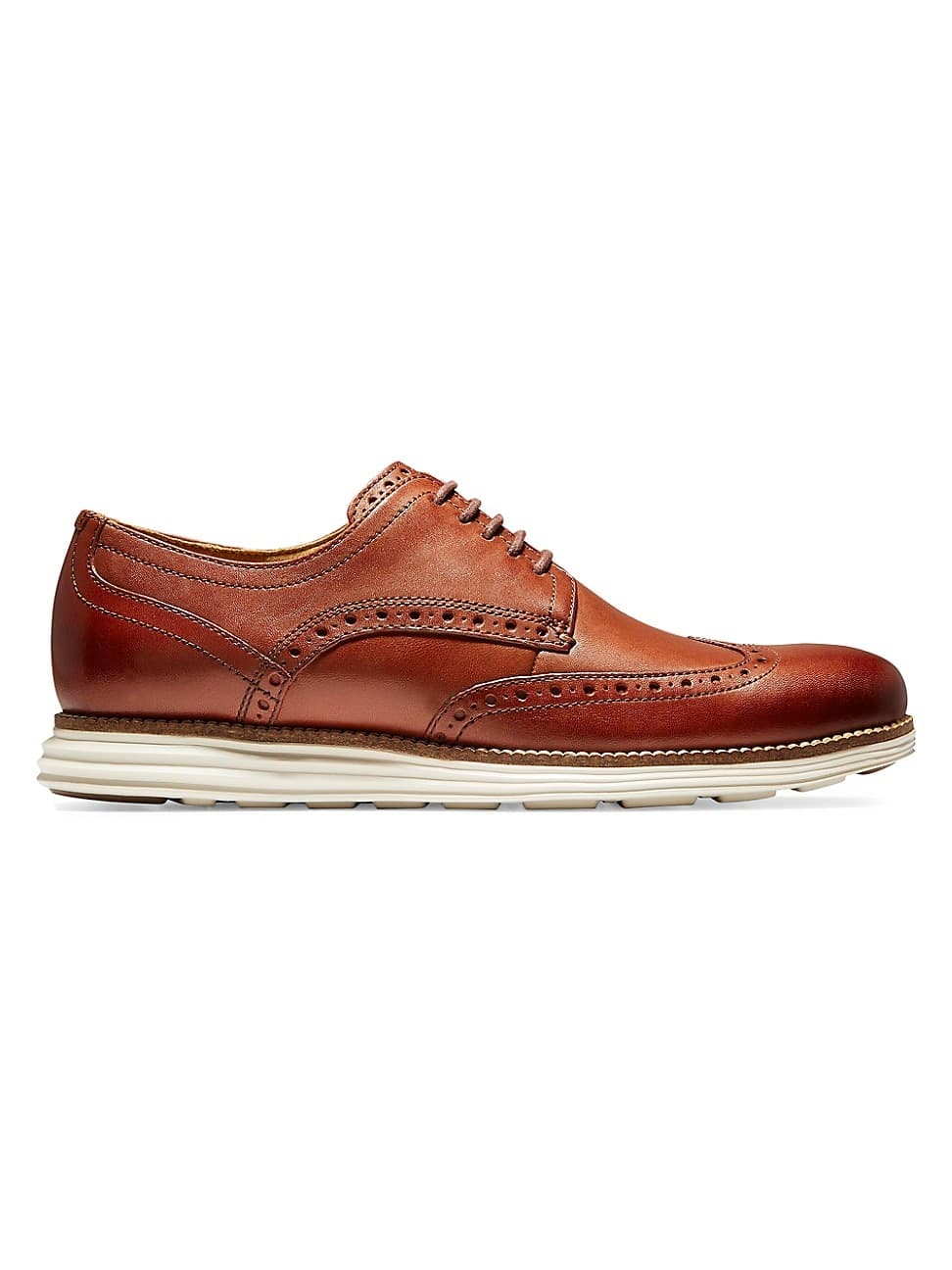 Brown leather Oxford shoes with ivory sole, featuring wingtip detailing and perforations, designed for men in size 7 D - Medium by Cole Haan.