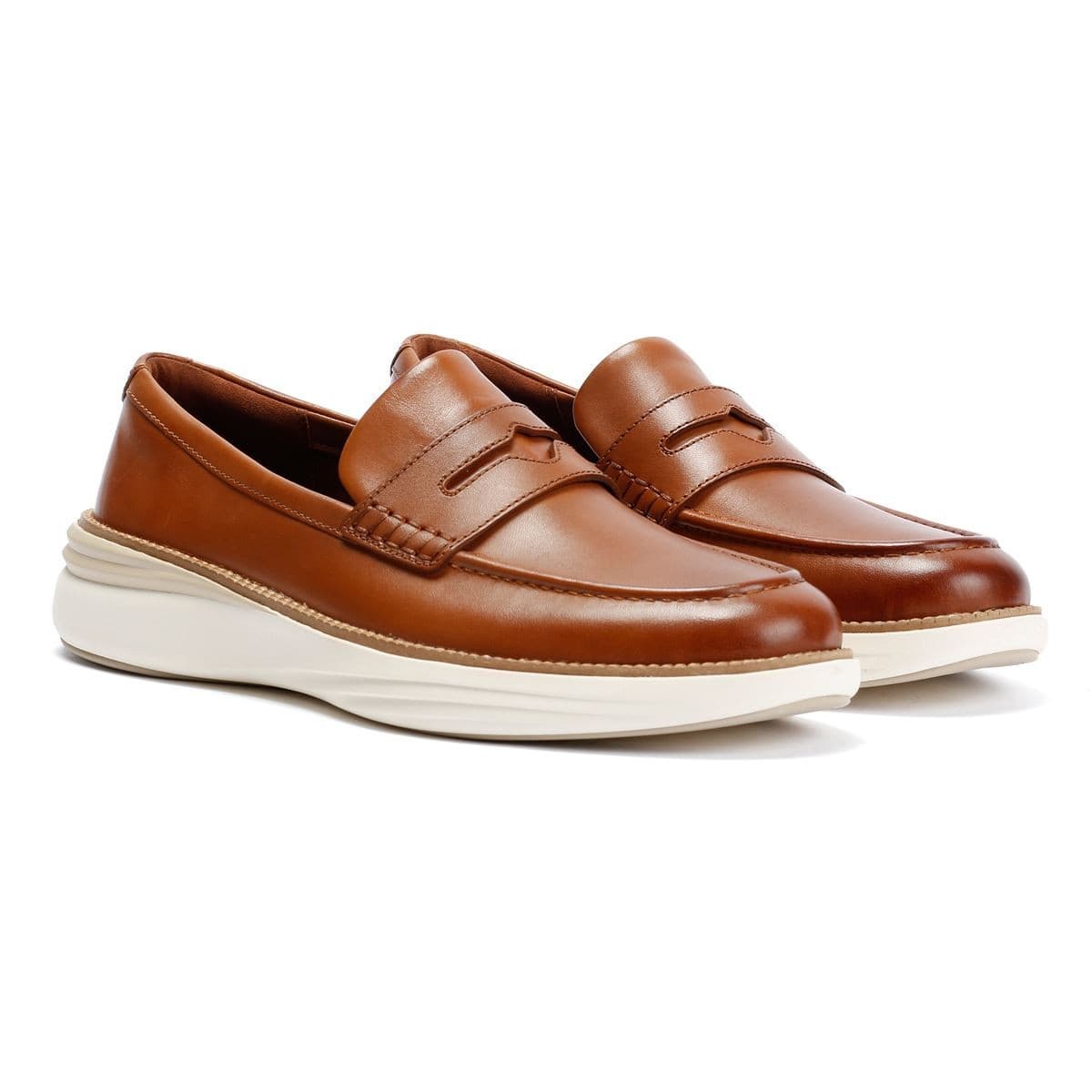 Brown leather penny loafers with a sleek design, featuring a raised seam and a white cushioned sole, size 7 by Cole Haan.