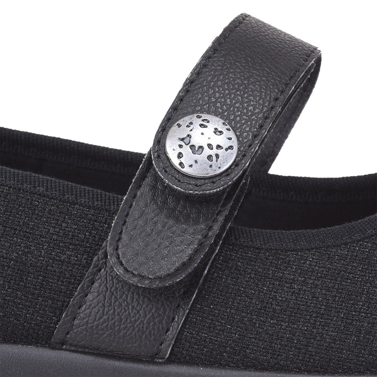 Black strap extension for shoes featuring a textured leather finish and a decorative silver button, designed for added comfort and adjustability.