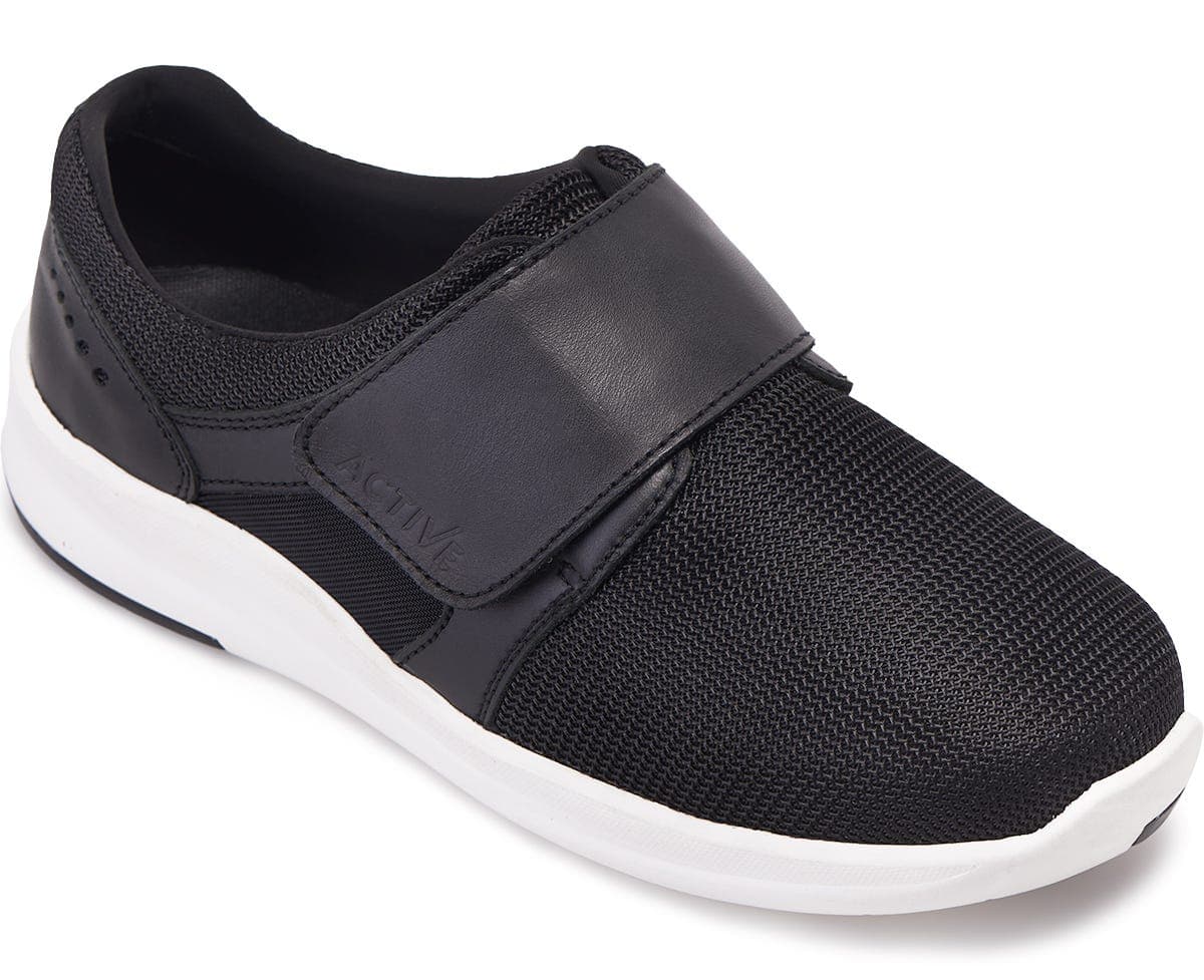Black mesh slip-on shoe with a wide fit, featuring a Velcro strap across the top for easy adjustment and a white rubber sole for comfort and support.