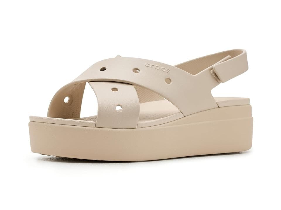 Cream-colored Crocs Brooklyn Cross Sandal featuring a cross-strap design, ventilation holes, and a chunky platform sole for added height and comfort.