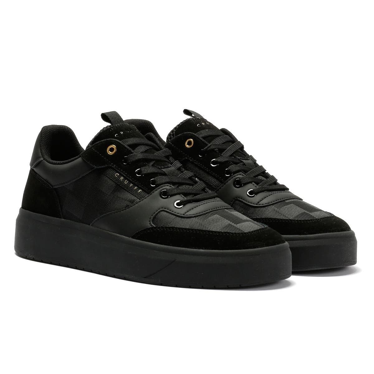 Black and gold Cruyff Terra Court men's trainers featuring a mix of smooth leather and textured fabric, with a thick black sole and gold eyelets.