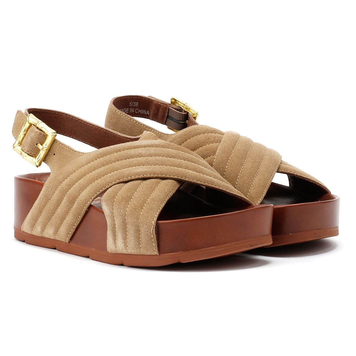 Taupe suede sandals with a quilted design, featuring a slingback strap and a chunky brown platform sole, accented by a gold buckle for added style.