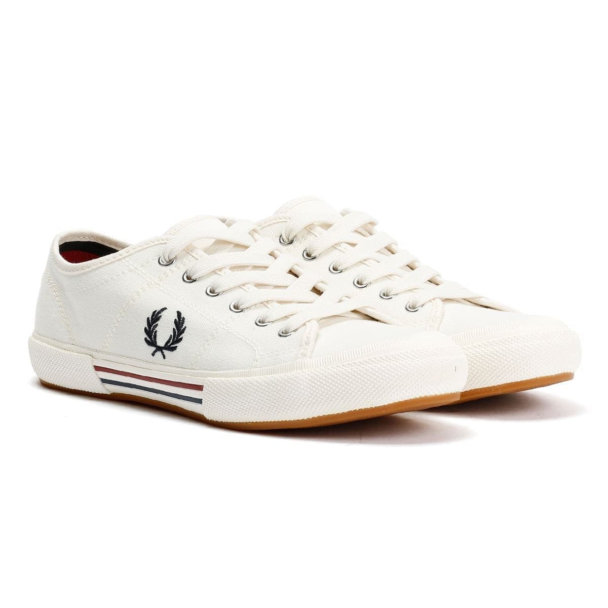 White canvas trainers featuring Fred Perry's iconic laurel wreath logo, with a rubber sole and striped detail in red and blue on the side.