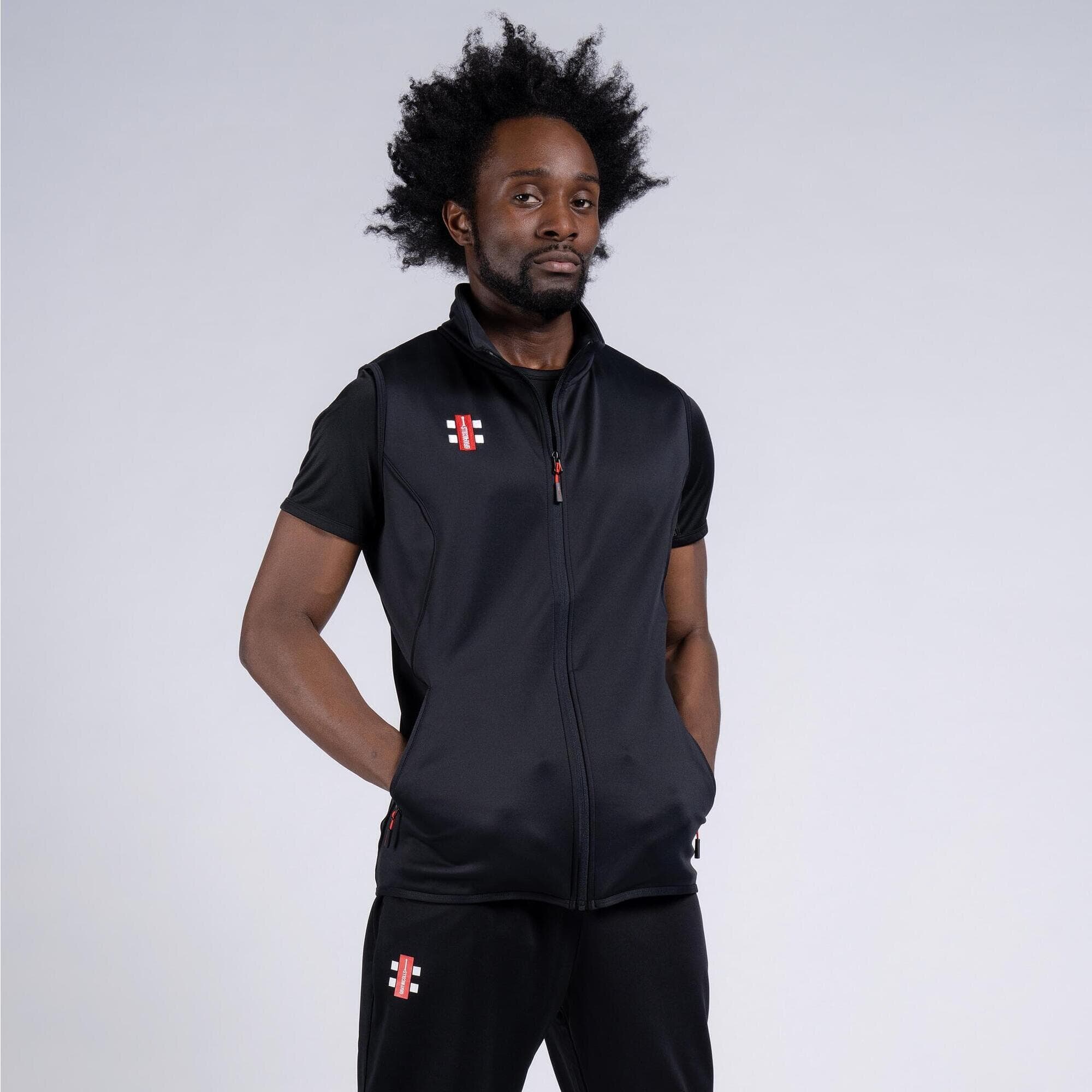 Black Gray-Nicolls Storm bodywarmer featuring a zip front, sleeveless design, and side pockets, made from a lightweight, water-resistant material.