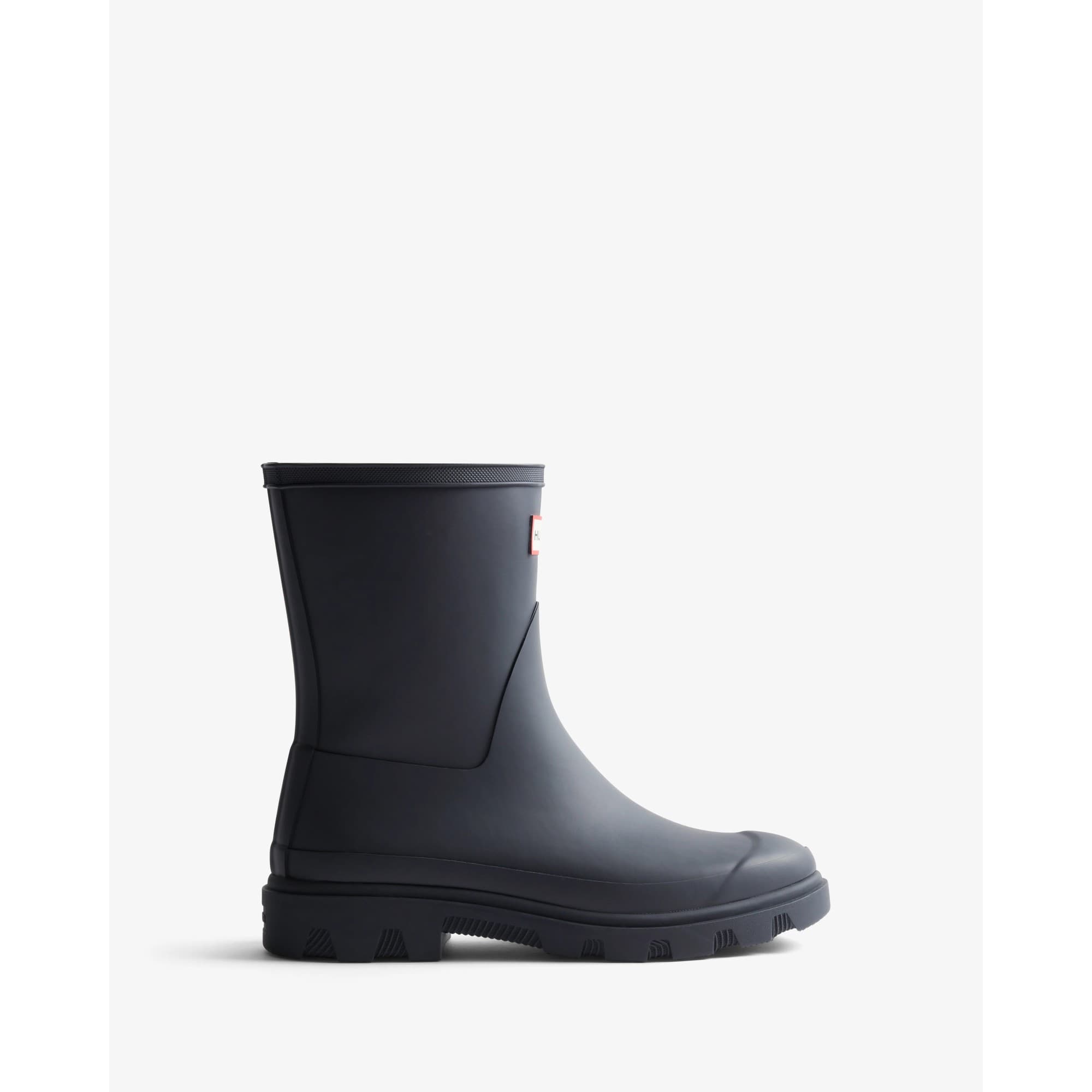 Navy blue rubber short Wellington boots for women by Hunter, featuring a sleek design, sturdy sole, and a logo patch on the side.
