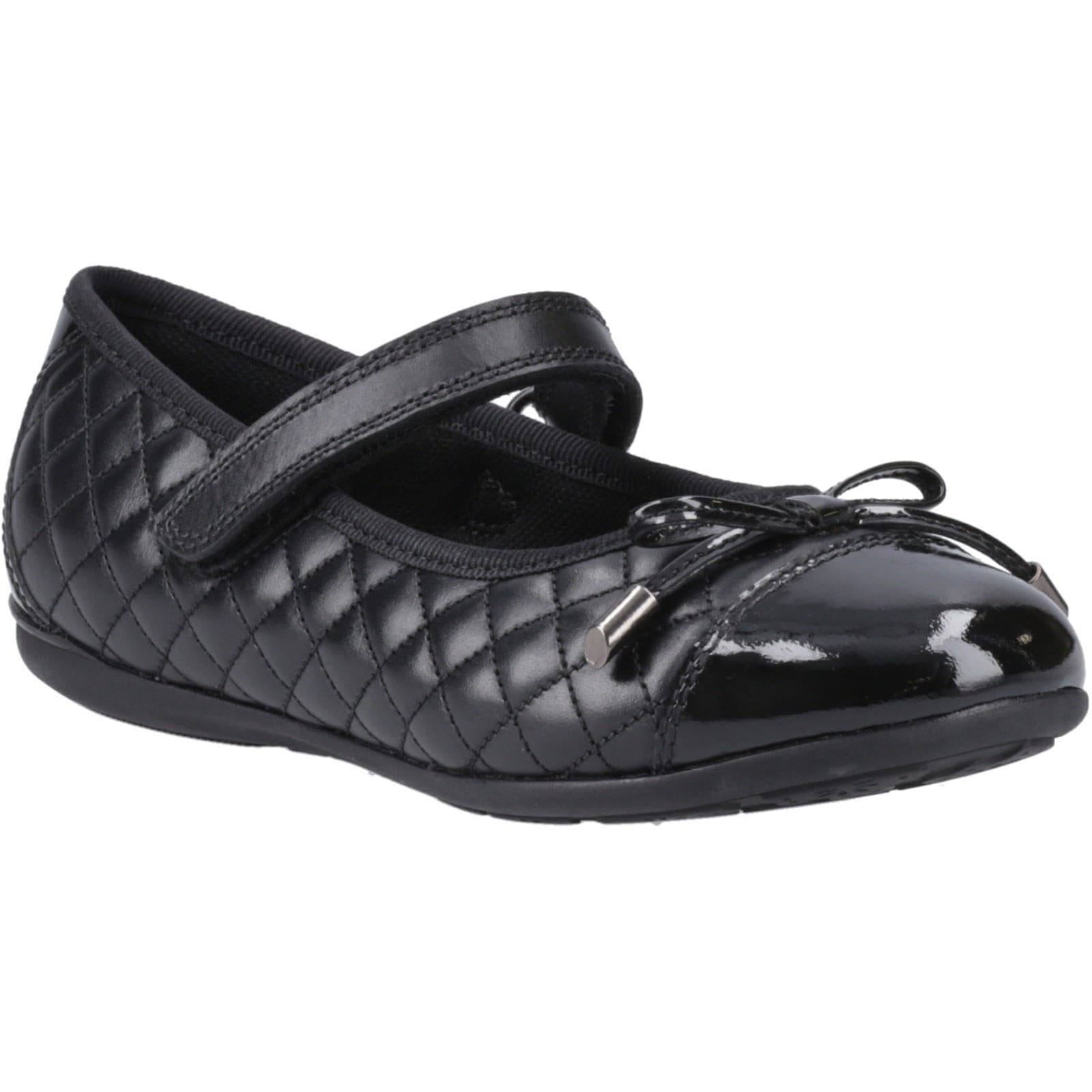 Black leather ballet flats featuring a quilted design, a decorative bow, and a strap across the instep for secure fit, ideal for youth.