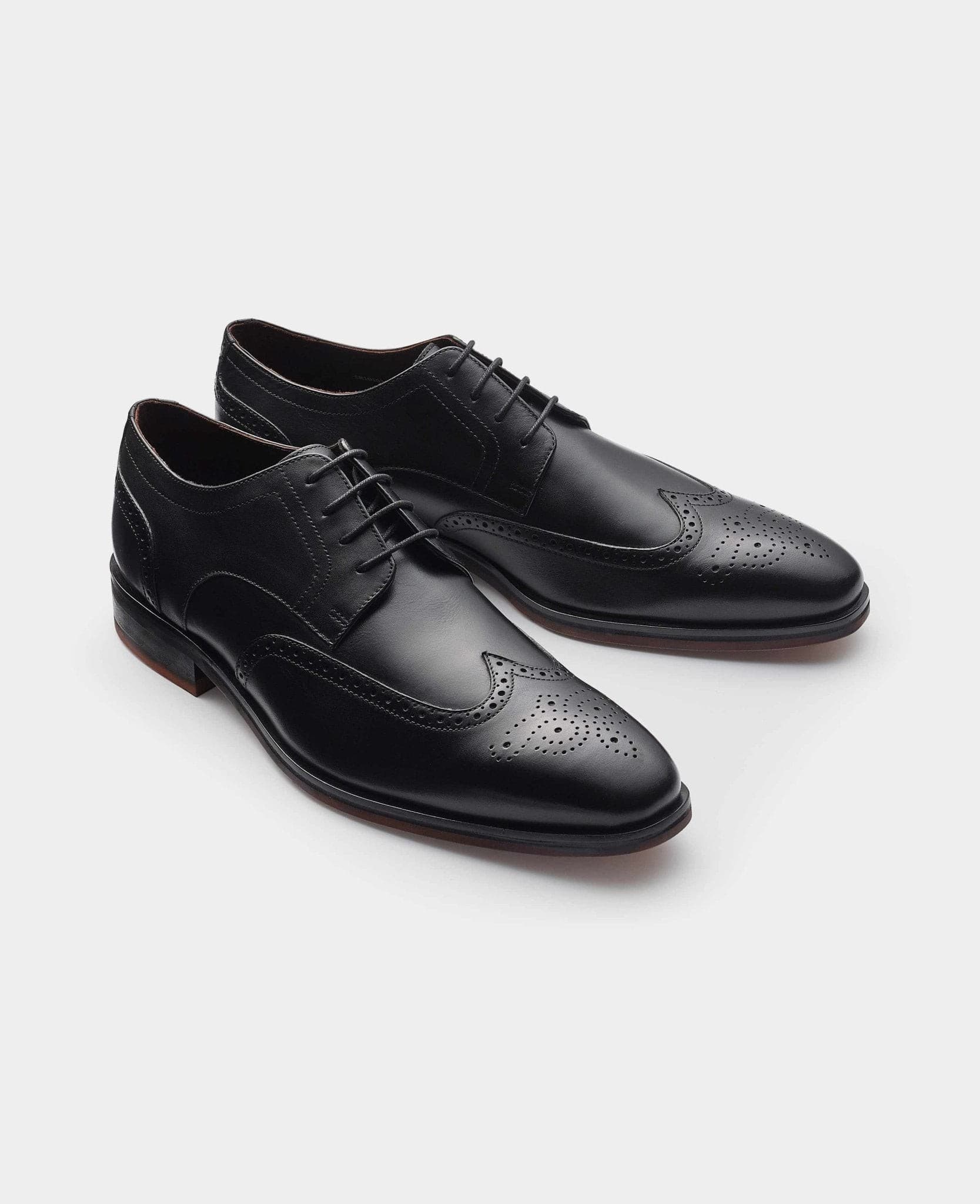 Men's black leather brogue derby shoes featuring intricate perforated detailing, a classic lace-up design, and a sleek silhouette, available in size 10 by Savile Row Company.