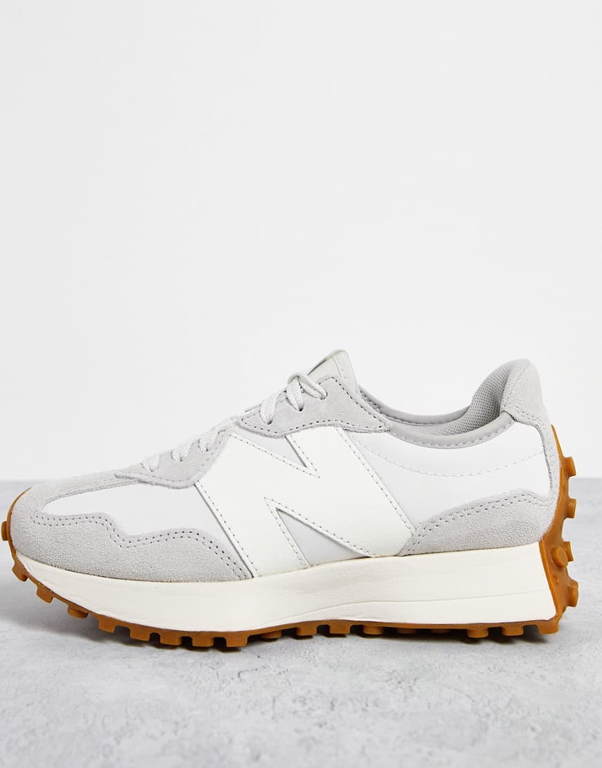 Light grey and white trainers with a textured upper, featuring a prominent 'N' logo, a cushioned sole, and a gum rubber outsole for traction.