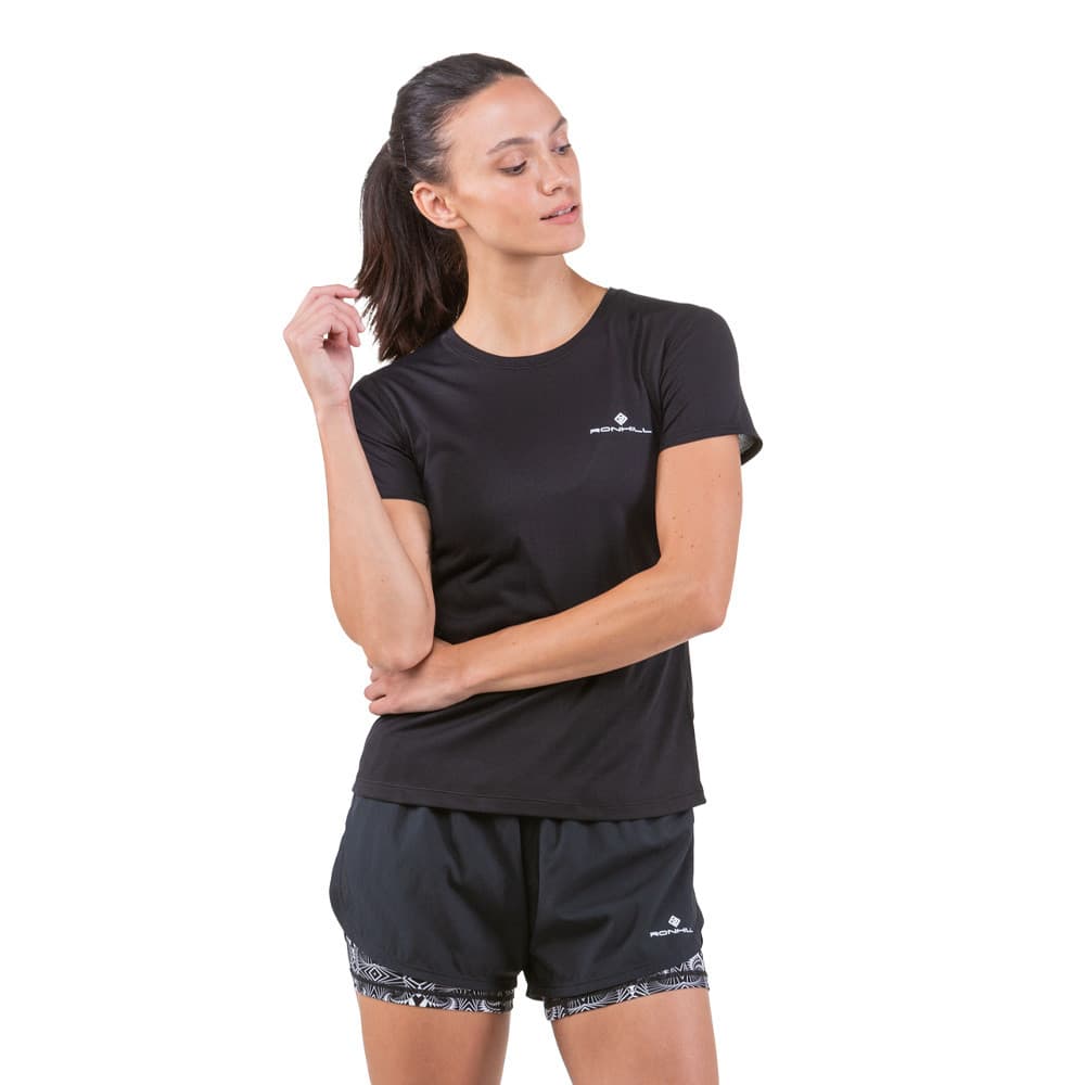 Black women's running shorts with a lightweight, breathable fabric, featuring a monochrome design and elastic waistband, paired with a matching black short-sleeve top.
