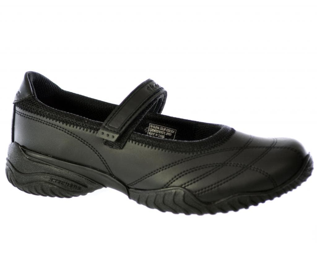 Black leather junior shoes with a sleek design, featuring a Velcro strap for easy wear and a textured rubber sole for grip.