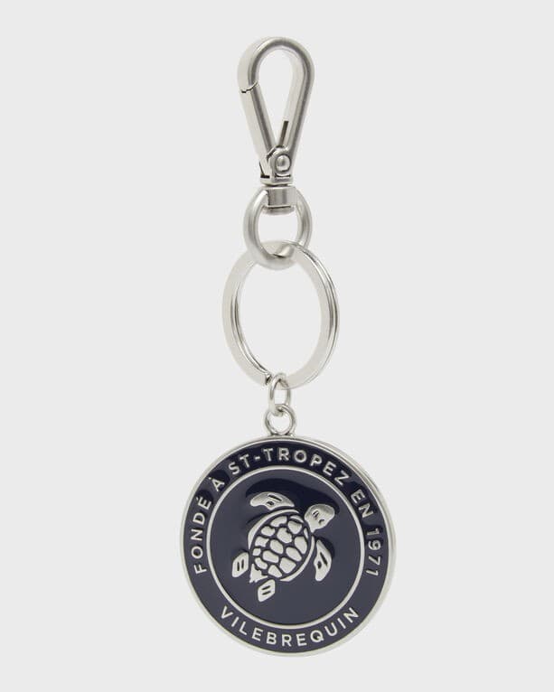 Unisex blue zamak keyring featuring a turtle design, silver-tone clip and ring, with "FONDÉ À ST-TROPEZ EN 1971" inscribed around the edge.