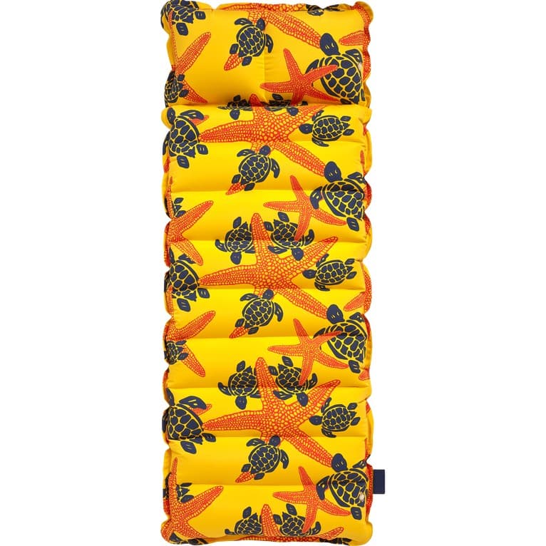 Yellow inflatable mattress featuring a vibrant pattern of red starfish and black turtles, designed for beach use, with a comfortable, cushioned surface.