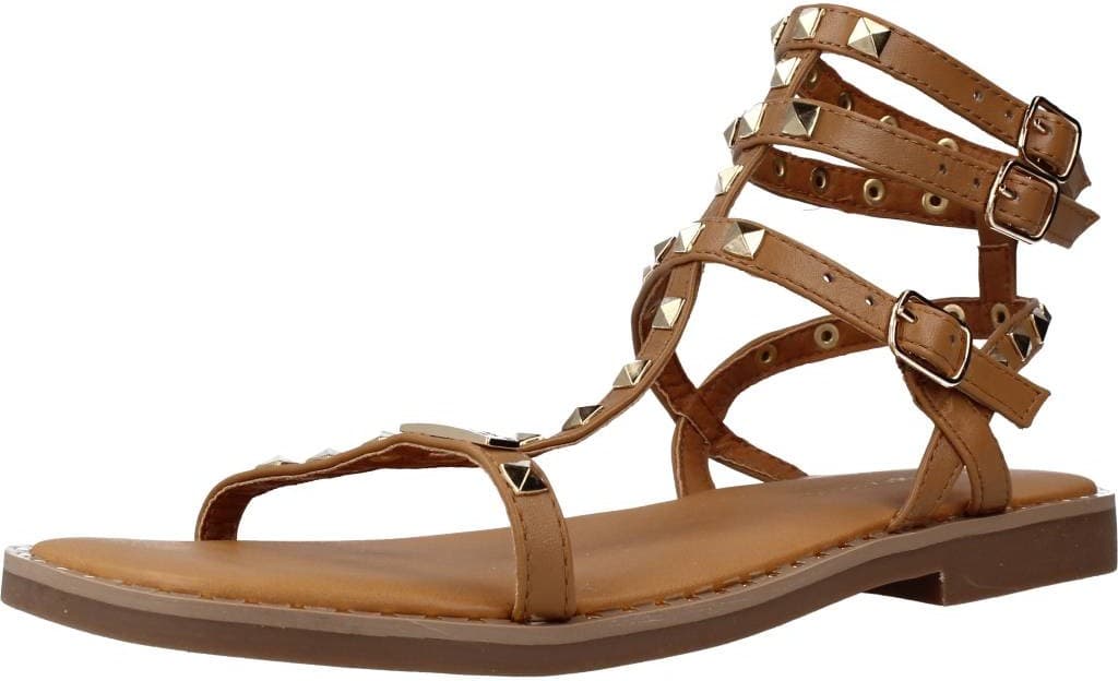 Tan strappy sandals featuring multiple buckles and metallic studs, with a flat sole and open-toe design, ideal for a stylish summer look.