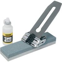 Stanley sharpening system with honing guide, gray sharpening stone, and lubricant bottle.
