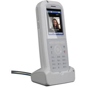White AGFEO DECT 77 IP phone with a TFT screen displaying a video call, featuring a numeric keypad and a sleek design, resting on a charging dock.