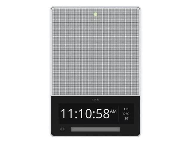 White rectangular device with a mesh speaker grille, digital clock display showing time and date, and a green indicator light at the top.