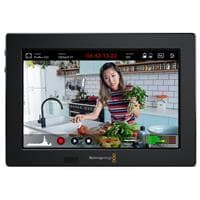 Blackmagic Design Video Assist features a 7-inch touchscreen display with a sleek black frame, showing a woman preparing food in a kitchen setting, with recording controls visible on the screen.