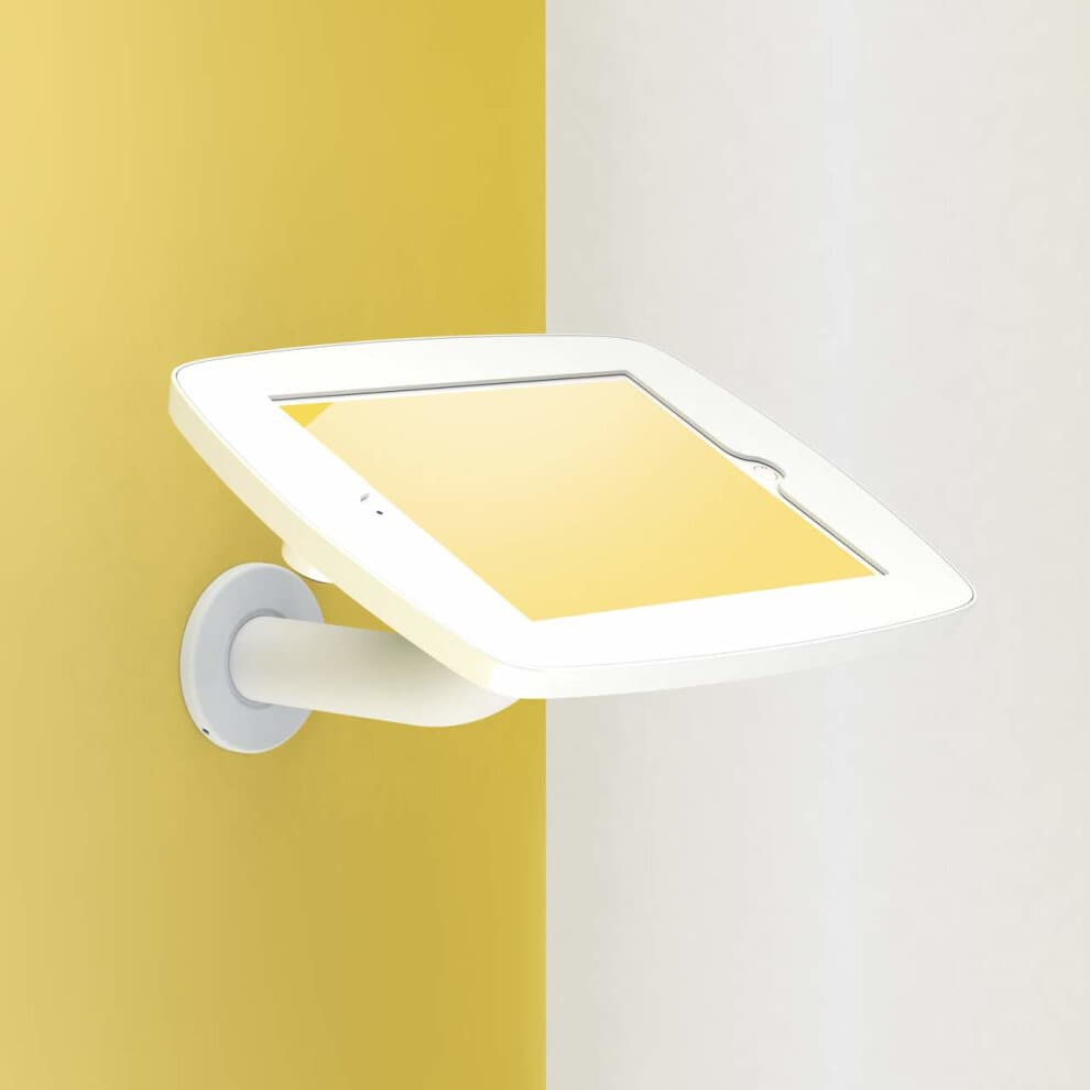 White wall-mounted tablet holder for Apple iPad 6th Gen, featuring a sleek design with a curved arm and a protective cover, set against a yellow and white background.