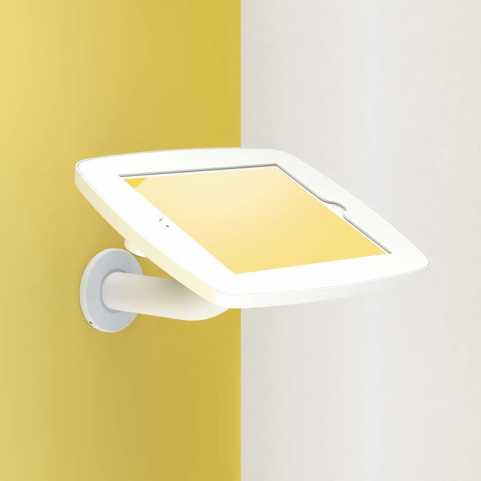 White Bouncepad Branch tablet holder for Microsoft Surface Pro 4/5/6/7, featuring a sleek design with a curved arm, mounted on a yellow and white wall.