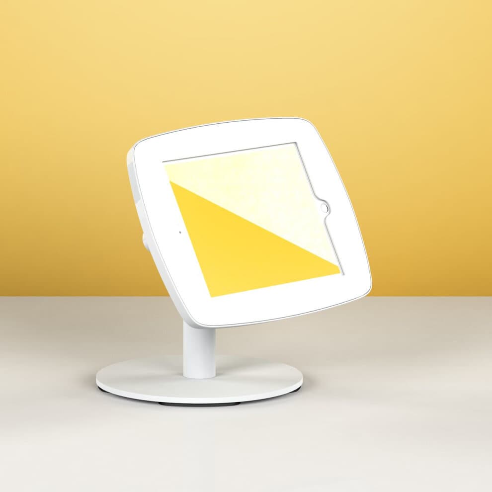 White Bouncepad Counter 60 stand for Apple iPad 5th Gen 9.7 (2017) features a sleek design with a sturdy base, angled display, and a vibrant yellow background.