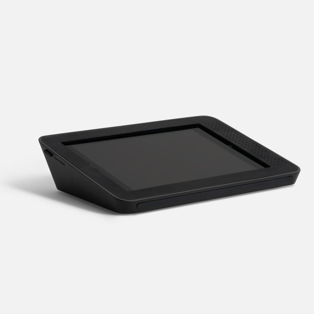 Black, angled tablet stand designed for Apple iPad 7th, 8th, and 9th Gen, featuring a sleek, durable material with ventilation holes and a secure slot for the device.