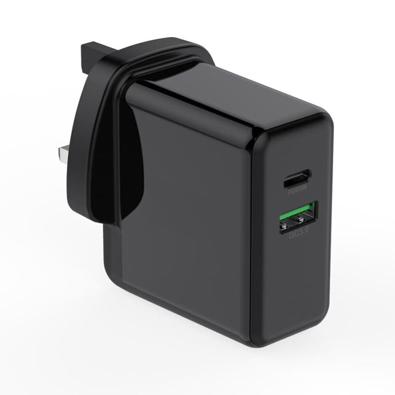 Black FDL charger with two ports: one USB-C PD and one USB-A QC3, featuring a sleek, glossy finish and compact design for efficient charging at 65W.