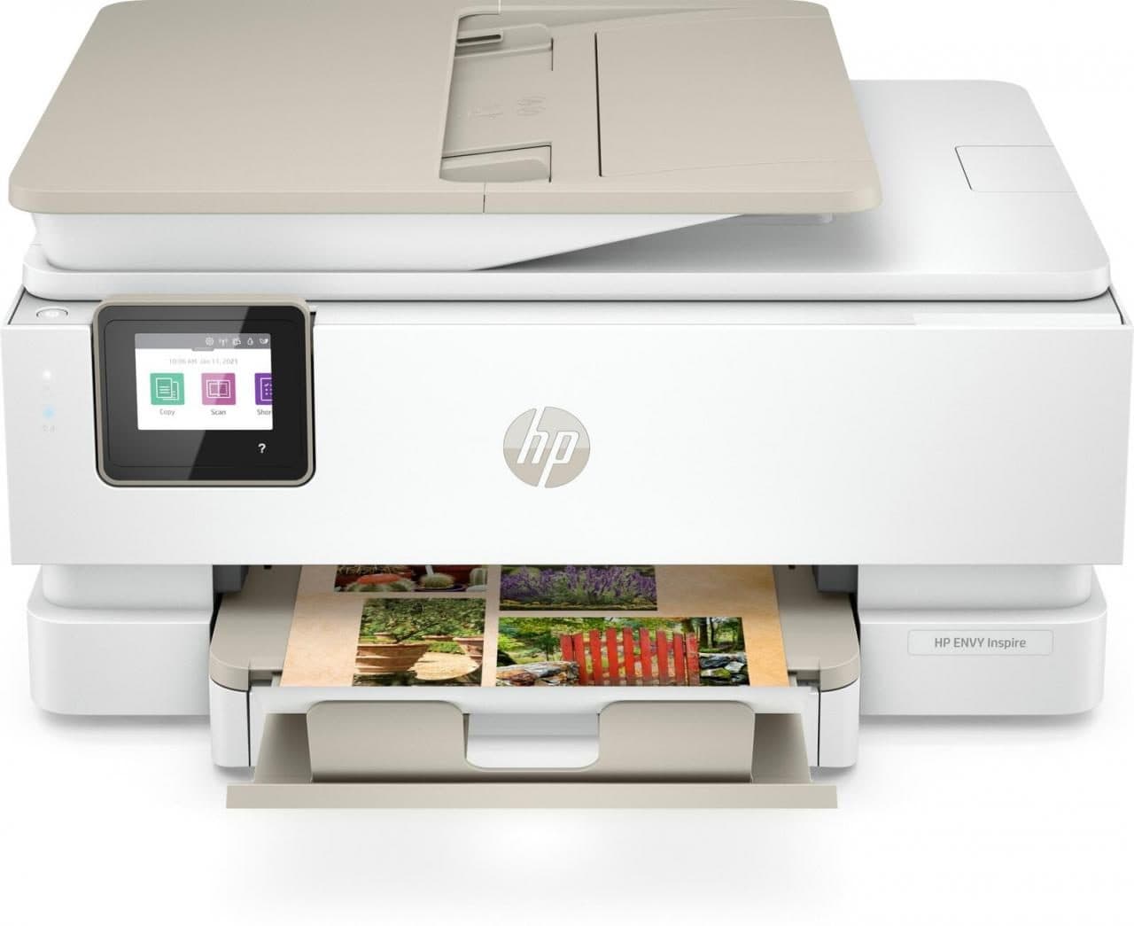 HP ENVY Inspire 7920e wireless all-in-one printer in white with a light beige scanner lid, featuring a touchscreen display and a paper tray showing printed photos.