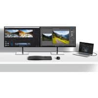 Dual HP Series 7 Pro monitors with slim bezels, silver stands, connected to a laptop, keyboard, and mouse on a white desk.