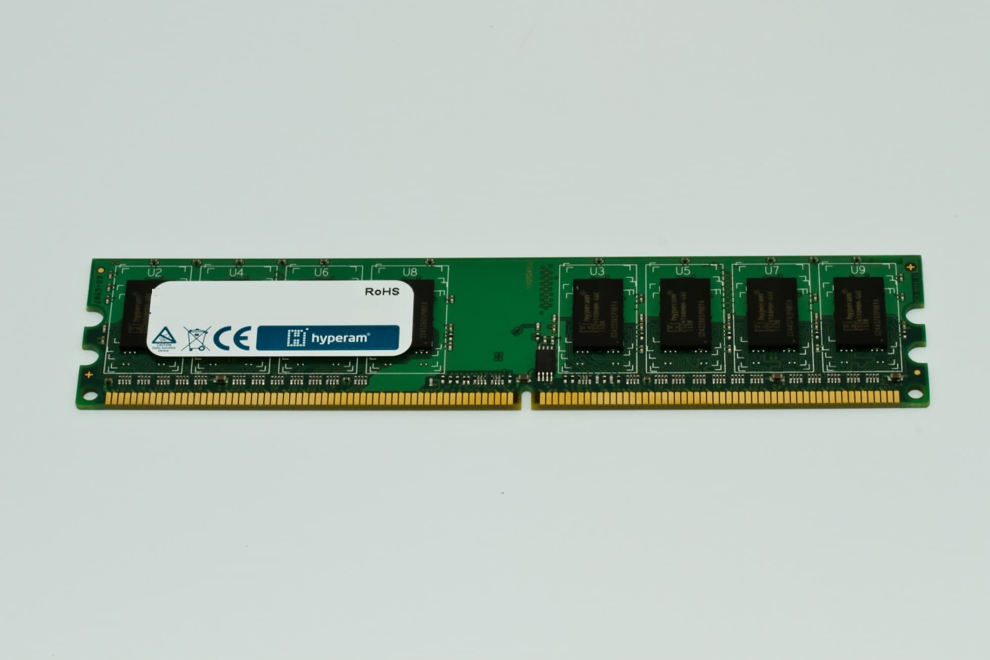 Green circuit board memory module with one 2 GB chip, featuring eight memory chips and a blue label with "RoHS" and "hyperam" branding.
