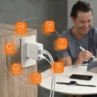 White j5create GaN USB-C 4-port charger plugged into wall, with multiple cables connected, sleek compact design.