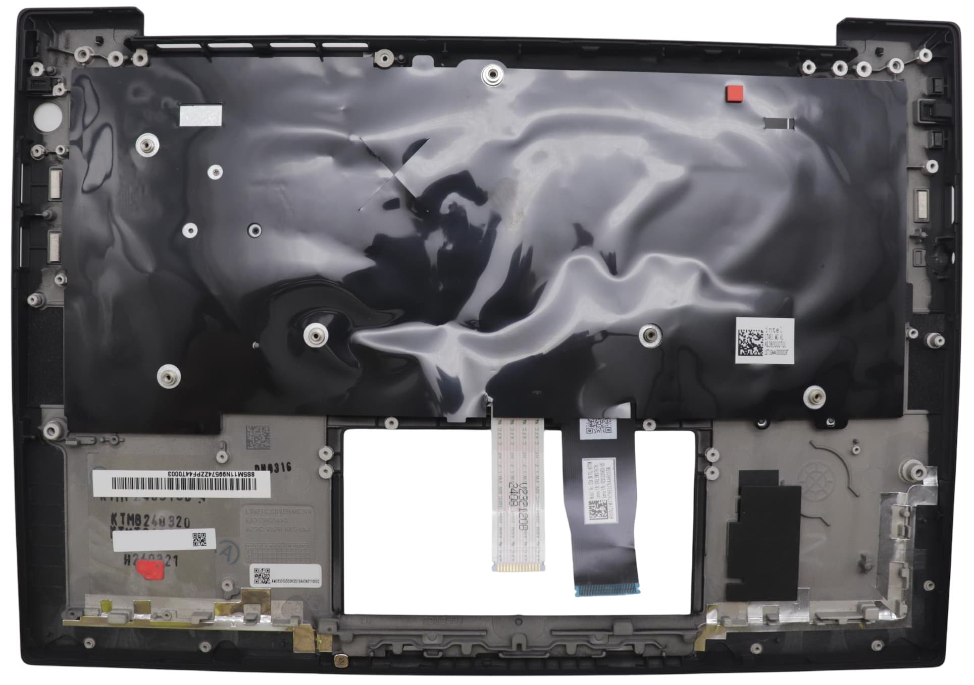 Black plastic laptop cover with a glossy finish, featuring various mounting points, connectors, and a rectangular cutout for the keyboard.