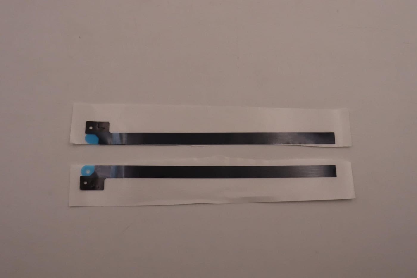 Two flat, black flexible cables with blue connectors on one end, laid flat on a white background, designed for Lenovo devices.