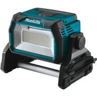 Makita cordless LED worklight, teal and black, with adjustable stand and large rectangular light panel.