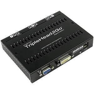 Matrox TripleHead2Go Digital Edition is a compact black device with ventilation slots, featuring multiple video output ports including DVI and VGA for connecting three monitors.